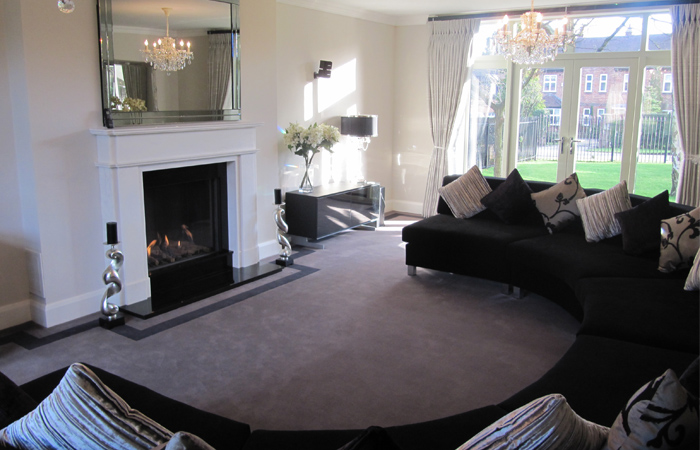 detached-house-harrogate-gallery-3 living-room-with-curved-seats-lots-of-cushions-and-lit-fire