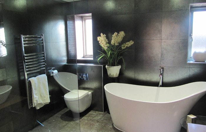 detached-house-harrogate-gallery-4 dark-tiled-bathroom-with-free-standing-bath-and-toilet
